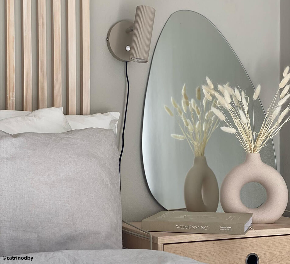 asymmetric mirror on bedside table