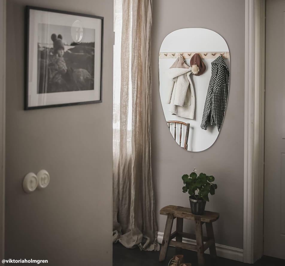 Oval mirror in hall