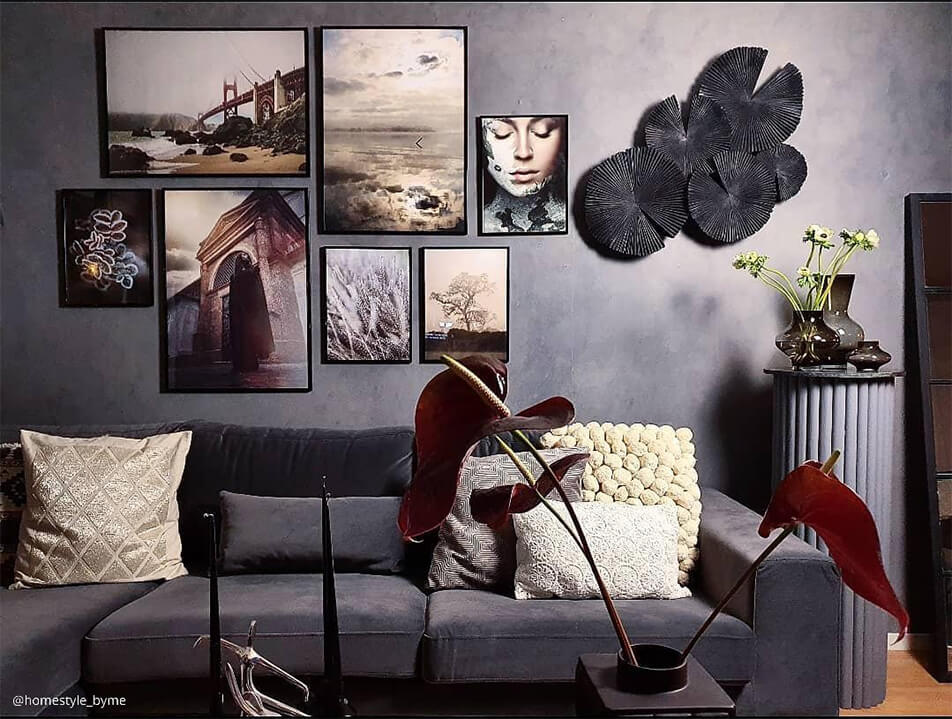 Sitting room in grey colour scale - photo wall above velvet sofa