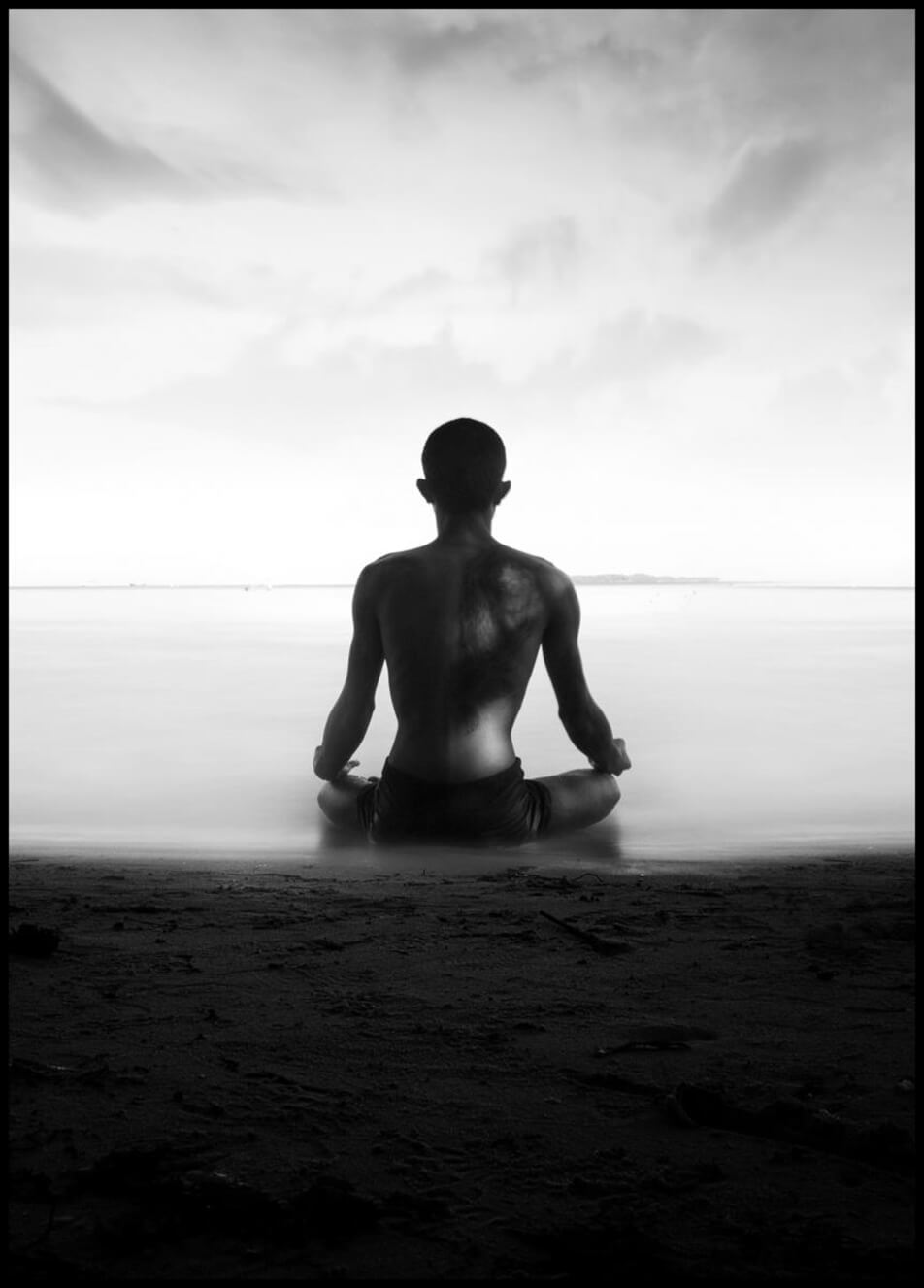 Poster with photo showing a man meditating by the seashore